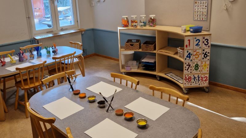 Bord med papper och penslar som ligger framme.